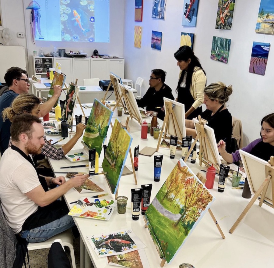 A painting class at easels